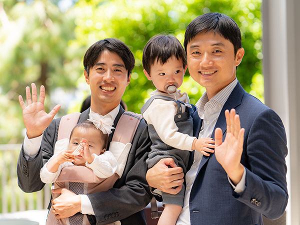 two students holding children